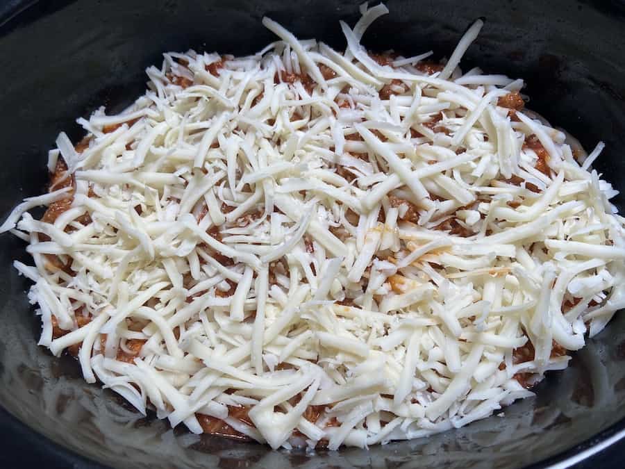 Lazy slow cooker lasagna topped with cheese