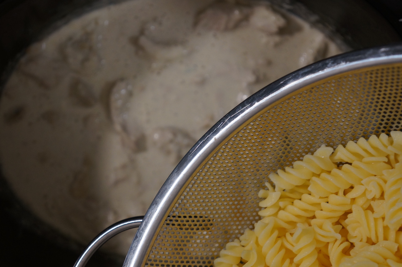 Chicken Caesar Pasta adding pasta