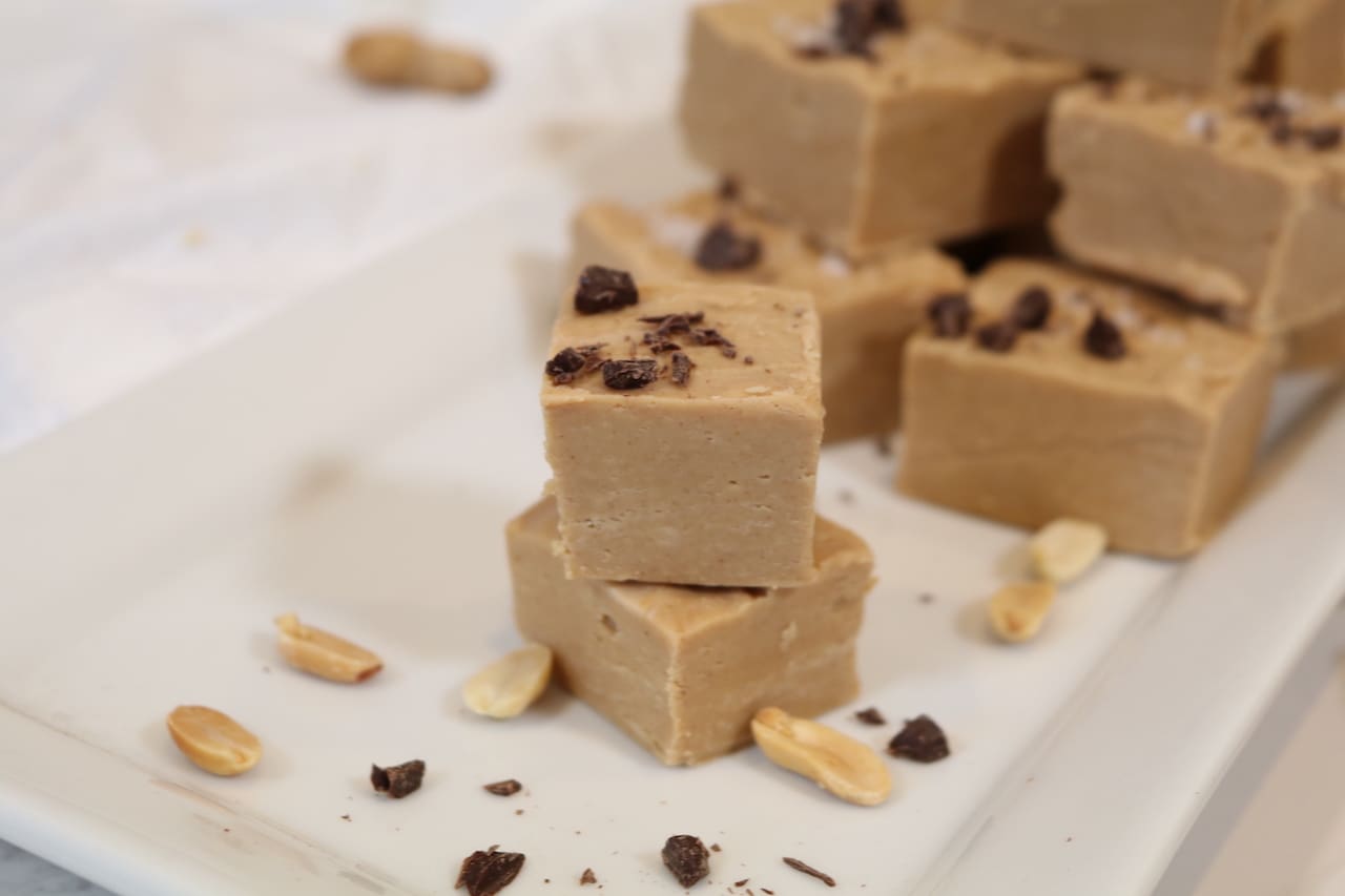 Stacked peanut butter fudge on white tray