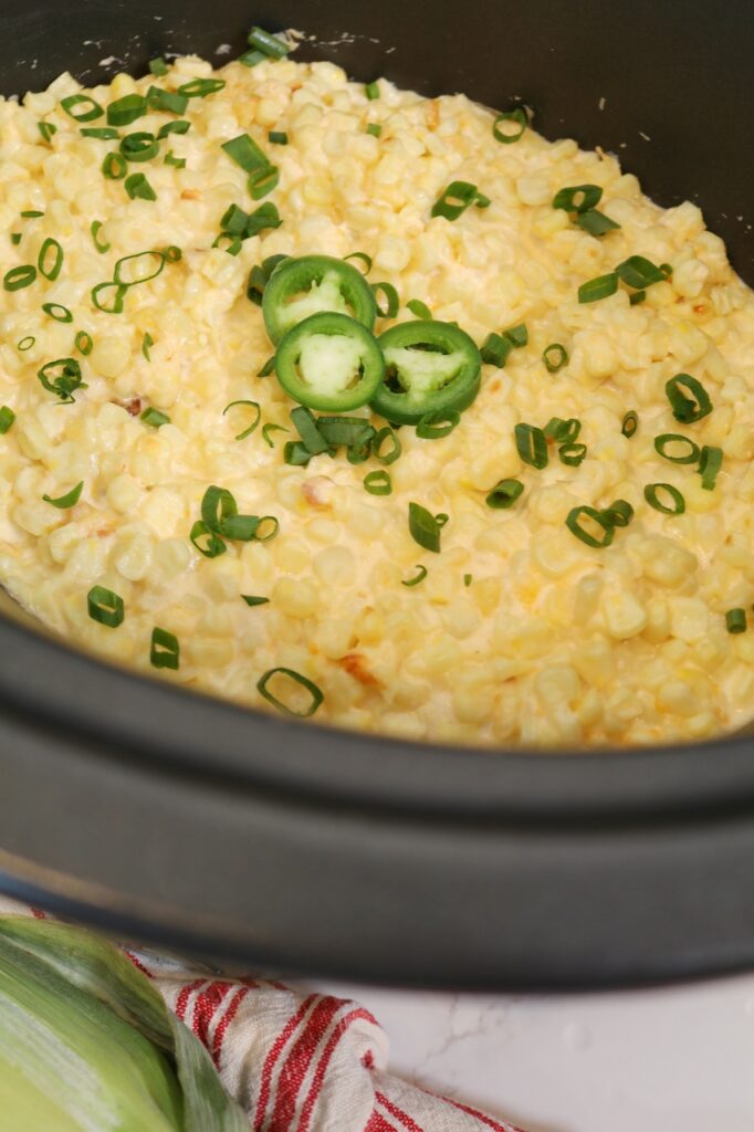 Corn Dip Cream Cheese in Crockpot with green onions and jalapenos