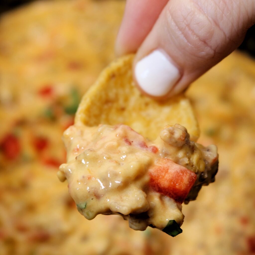 https://www.crockpotsandflipflops.com/wp-content/uploads/2023/02/Velveeta-Sausage-Dip-chip-square-small-1024x1024.jpeg