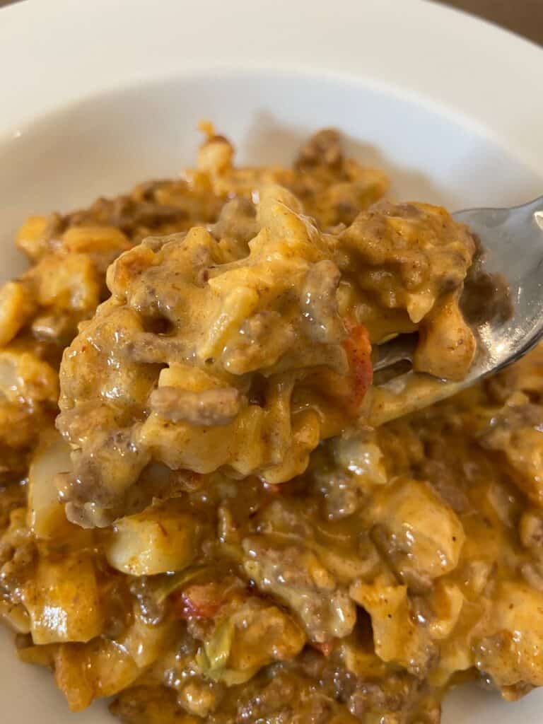 Taco Potato Casserole with a bite on a fork in the front.