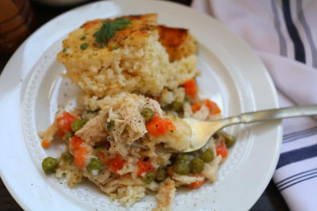 Chicken Cobbler Casserole on fork with pepper