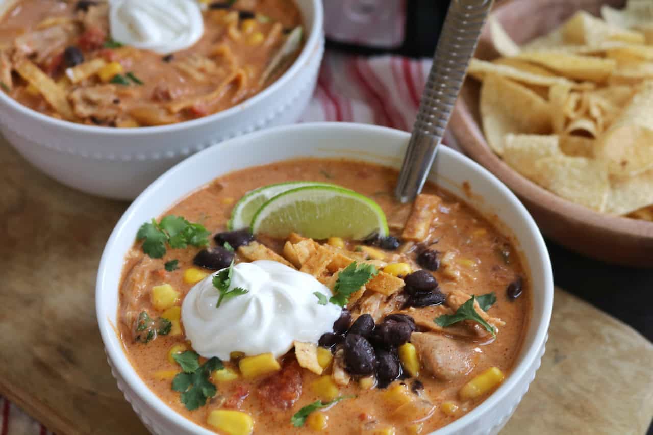 Bowl of soup up close with sour cream and spoon