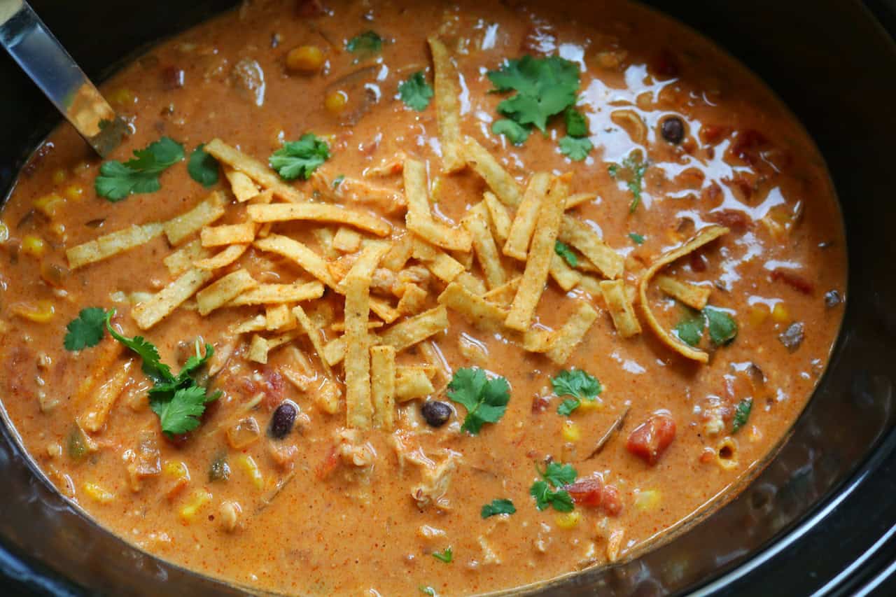 Chicken Chili Enchilada Soup finished in crockpot with toppings.