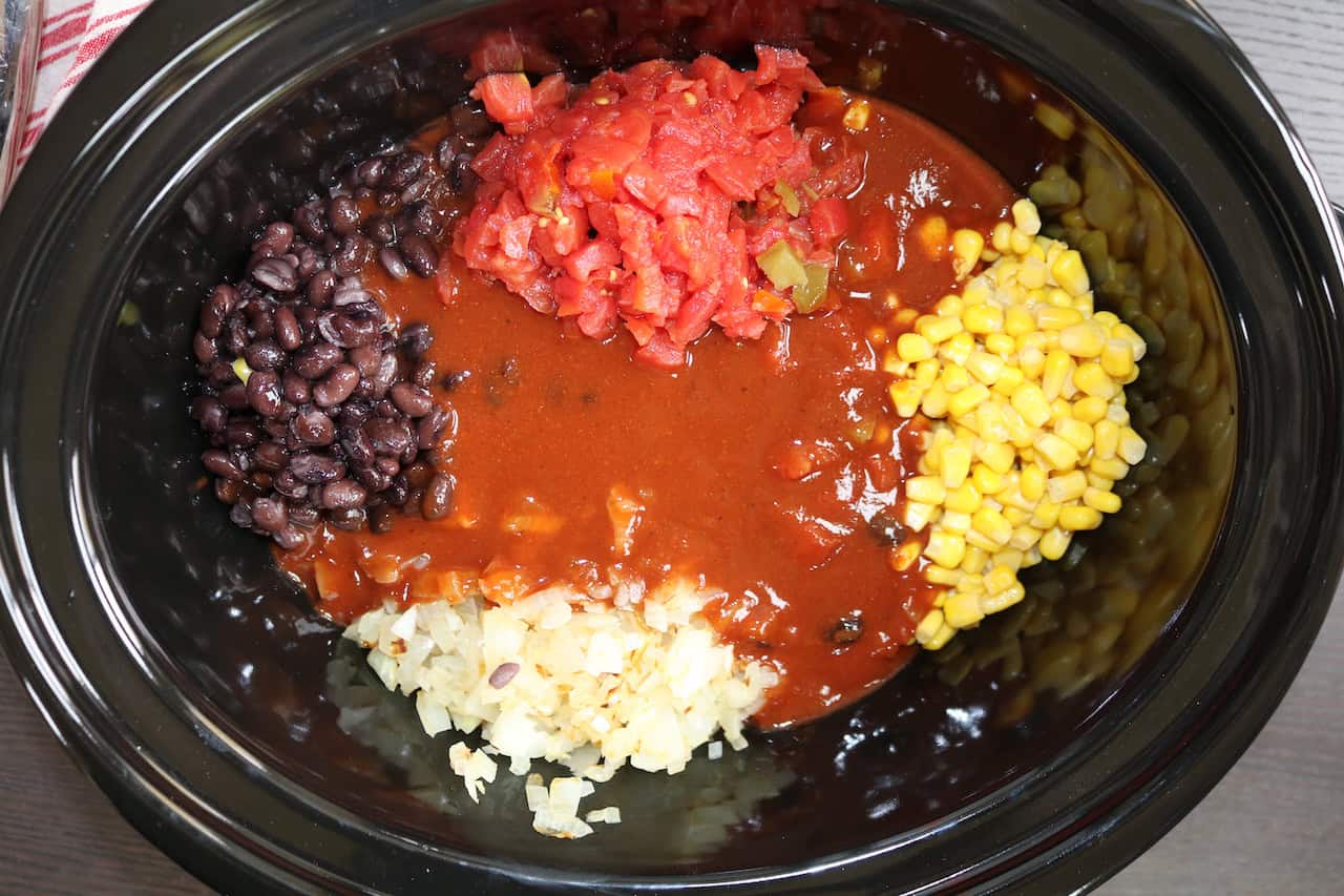 Chicken Thighs, corn, onions, Rotel Tomatoes, enchilada Sauce and black beans in crockpot.