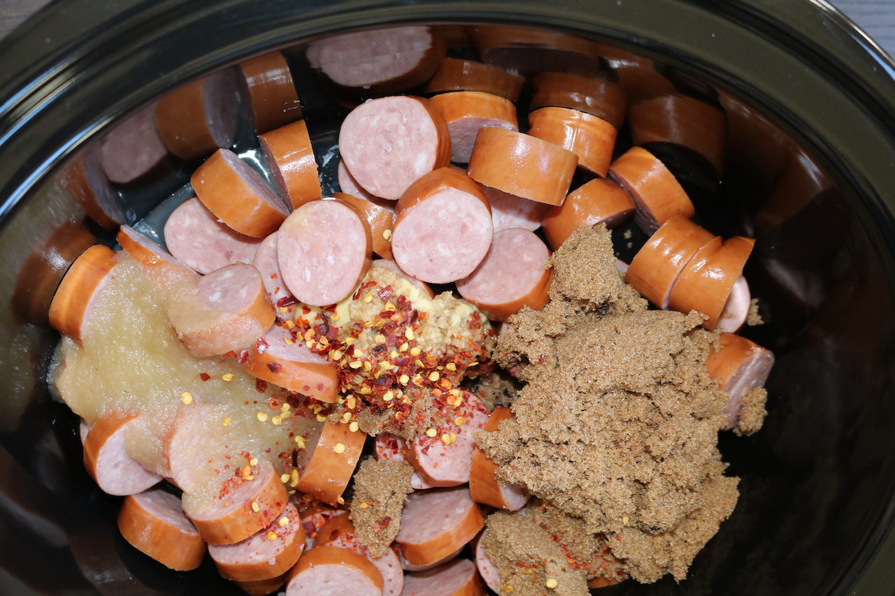  Kielbasa, brown sugar, dijon, garlic, red pepper flakes and apple sauce in crockpot