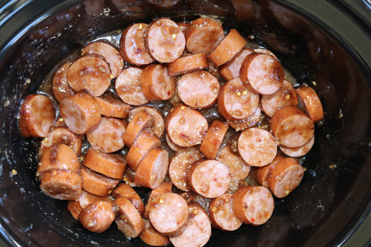 Kielbasa, brown sugar, dijon, garlic, red pepper flakes and apple sauce stirred together in crockpot