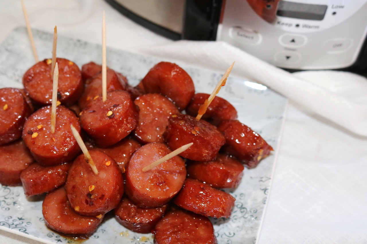 Kielbasa Appetizer Recipe with toothpicks on blue plate.