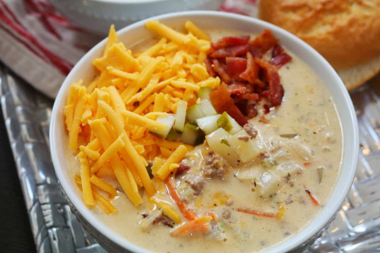 Crockpot Cheeseburger Soup with Bacon in white bowl with toppings