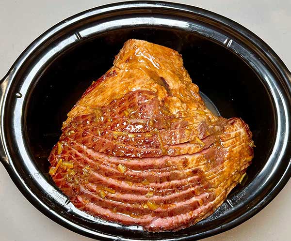 Pour the liquid glaze on the ham